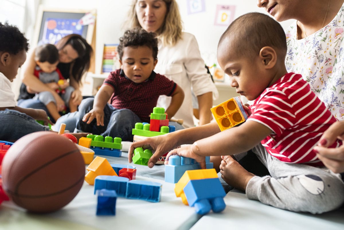 Family day with toddlers playing blocks at a preschool & child care center Serving Smithfield, RI.