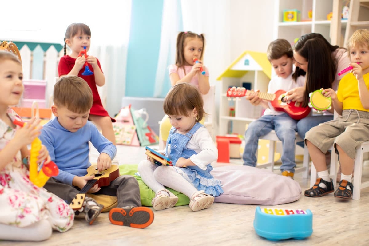 Toddlers plating with musical instruments at a preschool & child care center Serving Smithfield, RI.