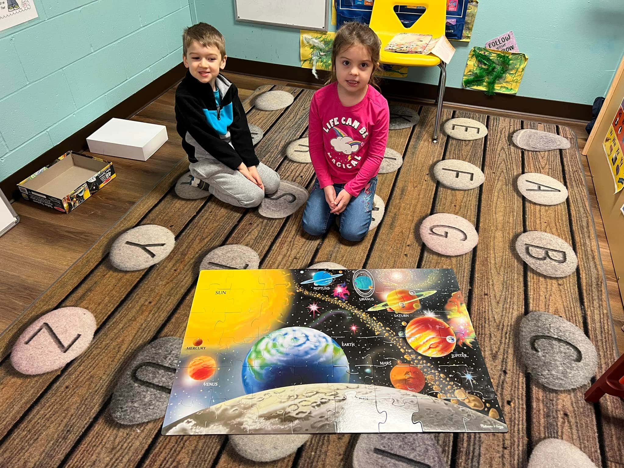 Preschoolers learning space puzzle at a preschool & child care center Serving Smithfield, RI.